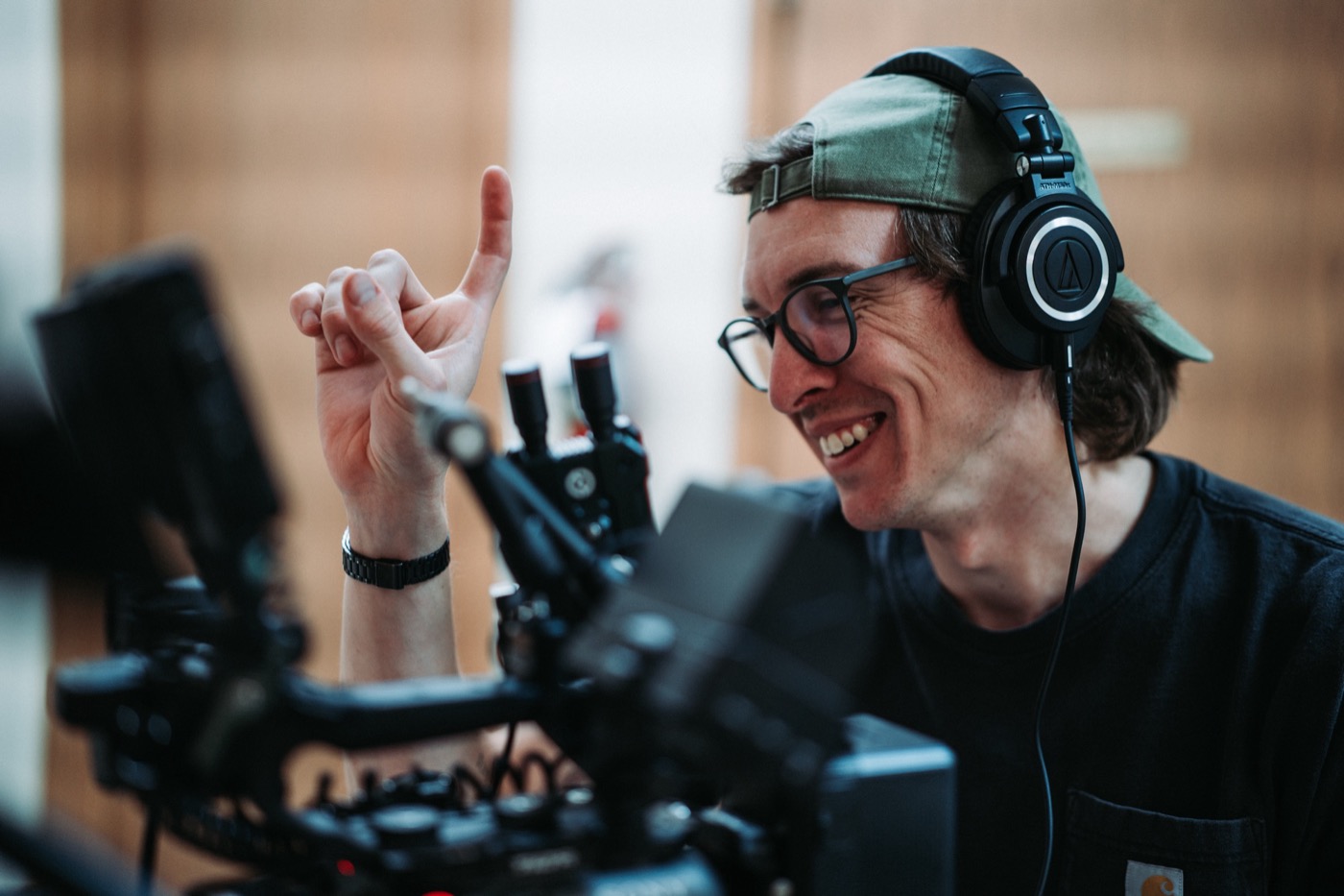 Ian Hoyt in headphones at the monitor, smiling at a take
