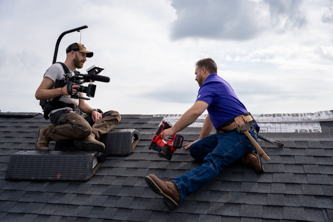 Camera operator and roofer on a rooftop during the New Heights shoot