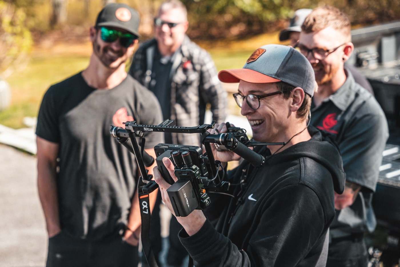 Ian Hoyt on set with a cinema camera, laughing with the crew