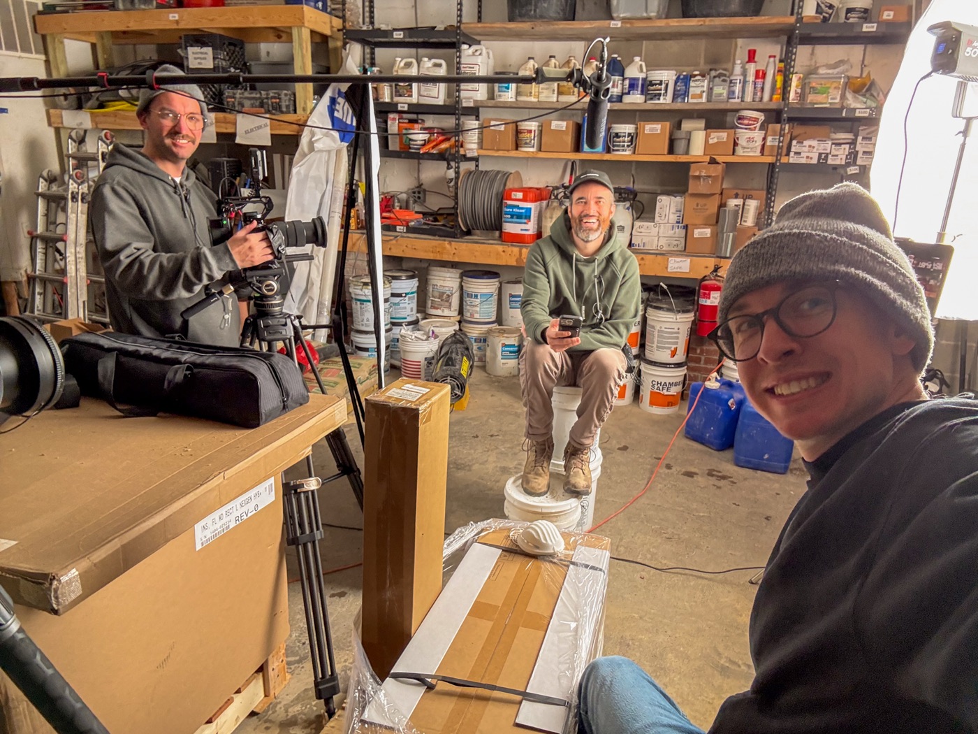 Ian Hoyt taking a selfie on a garage set with the crew rolling behind him